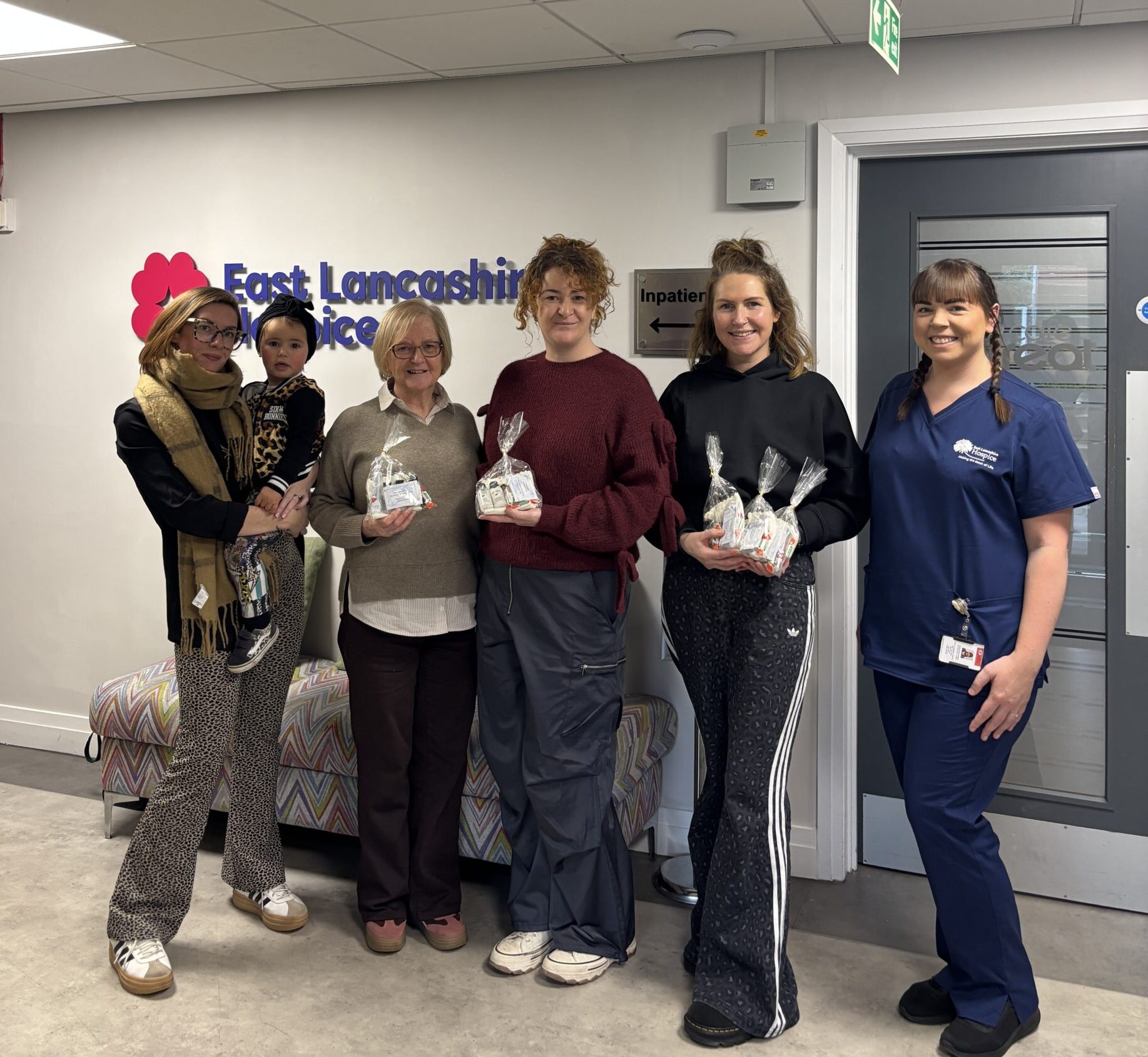 Kevin Andrews' family at East Lancashire Hospice with the packs their fundraised for and donated to the Hospice.